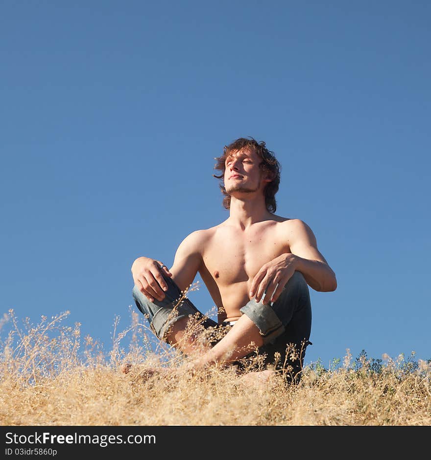 Man meditating in park