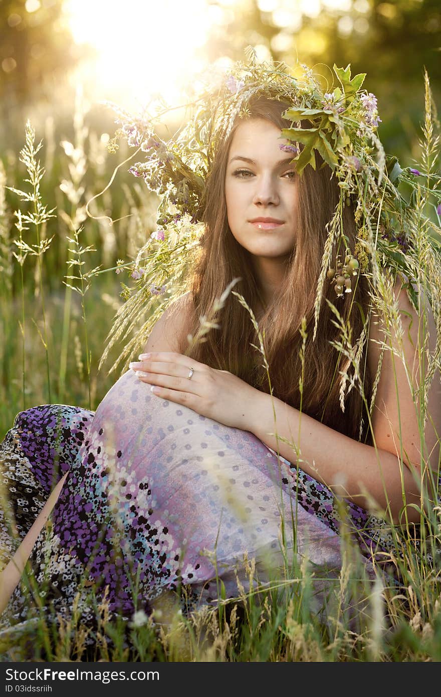 Woman Sitting On Grass In Park