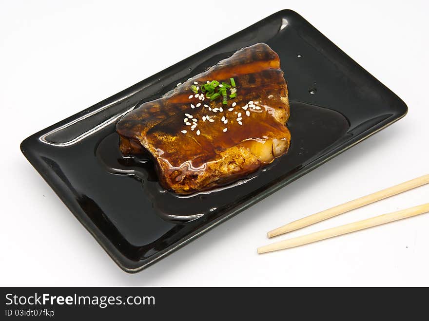 Japanese food style , Saba fish grilled with sauce in the plate on white background