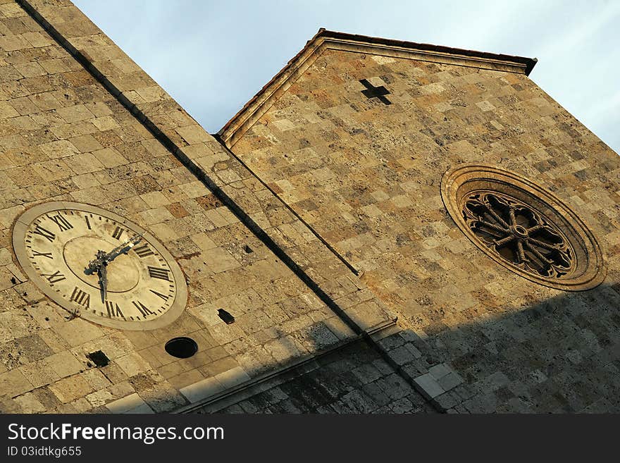 The old clock on the church in Italy. The old clock on the church in Italy