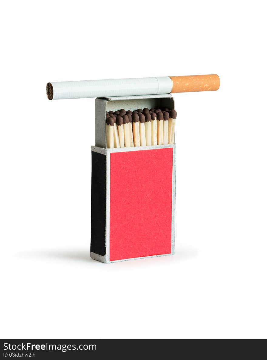 Cigarette lying on open matchbox. Isolated on white with clipping path. Cigarette lying on open matchbox. Isolated on white with clipping path