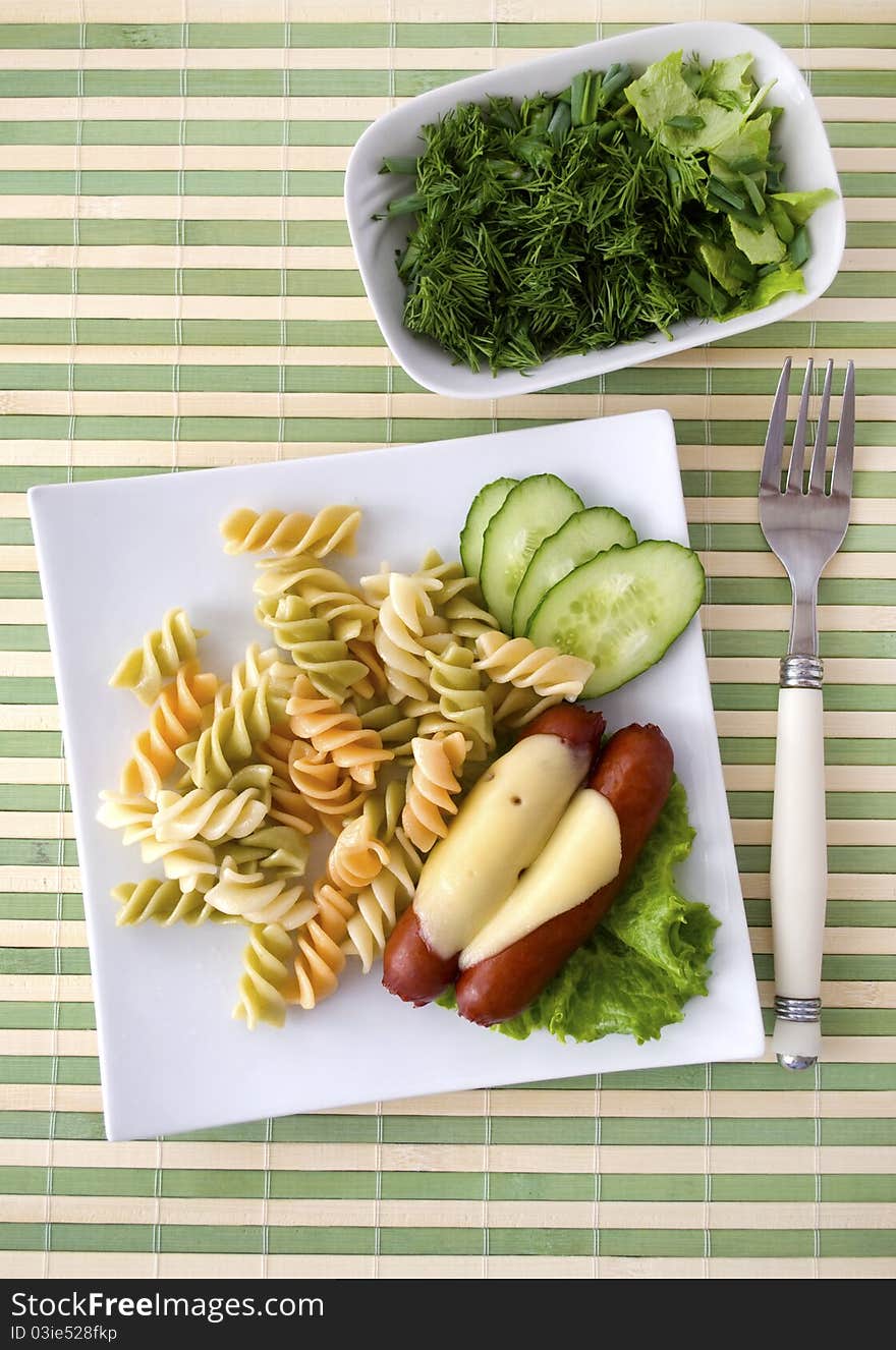 Breakfast: pasta, cucumbers and sausages