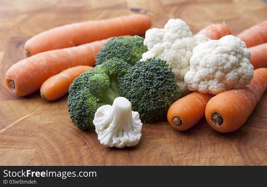 Simple arrangement of Vegetables on a wooden chopping board