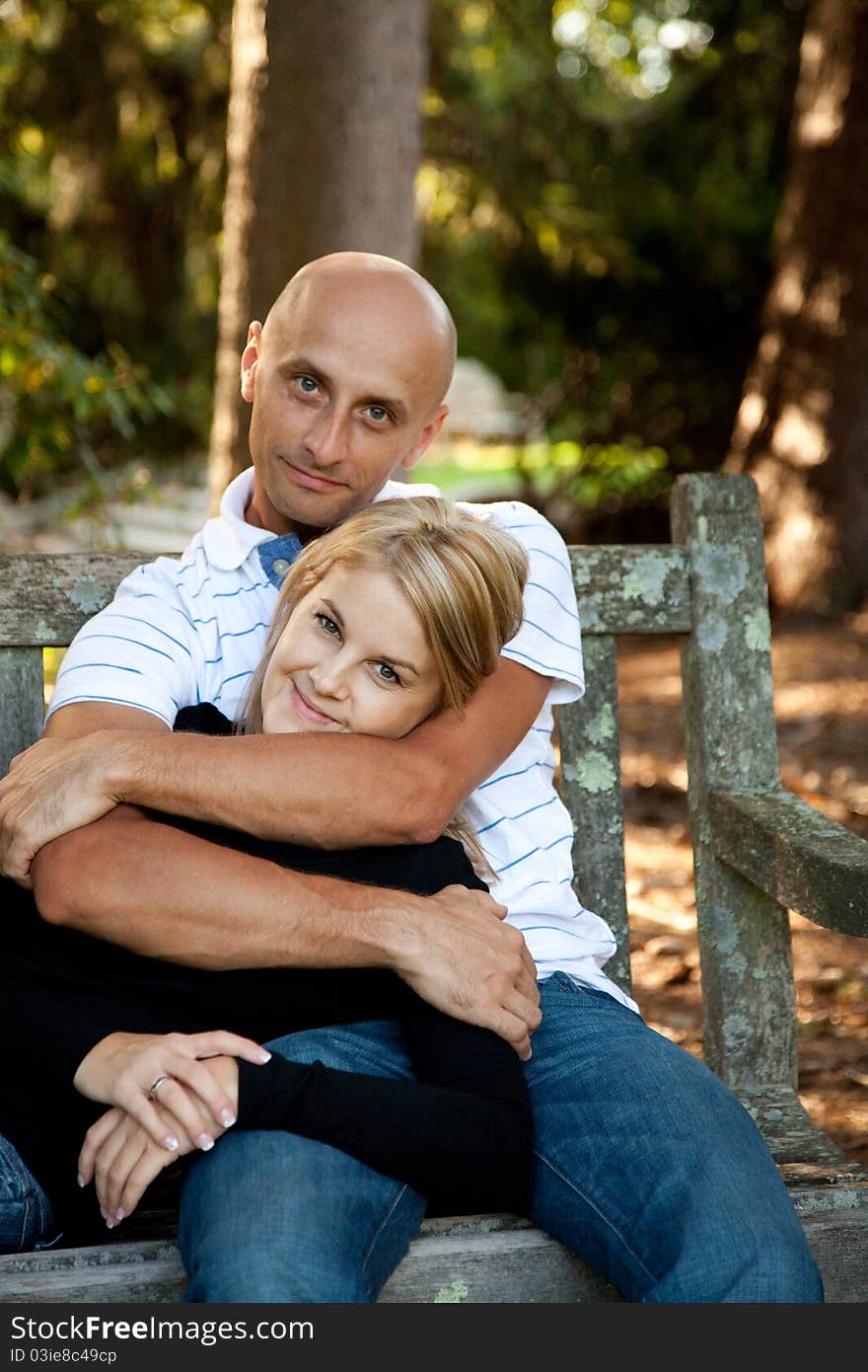 Couple in love, together on a park bench