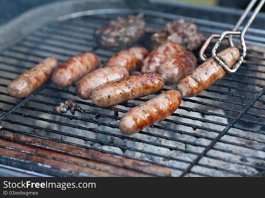 Summer BBQ with sausages and burgers. Summer BBQ with sausages and burgers