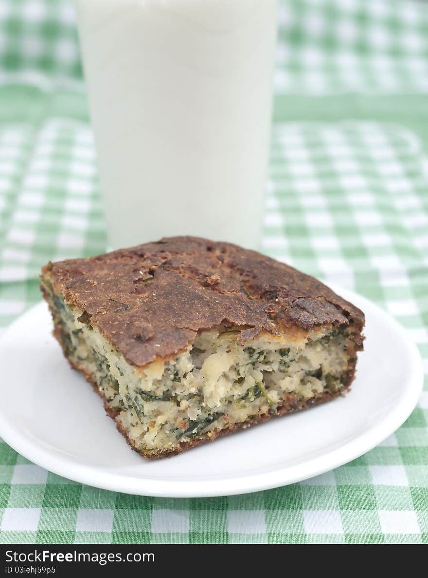 Spinach pie and milk on the table