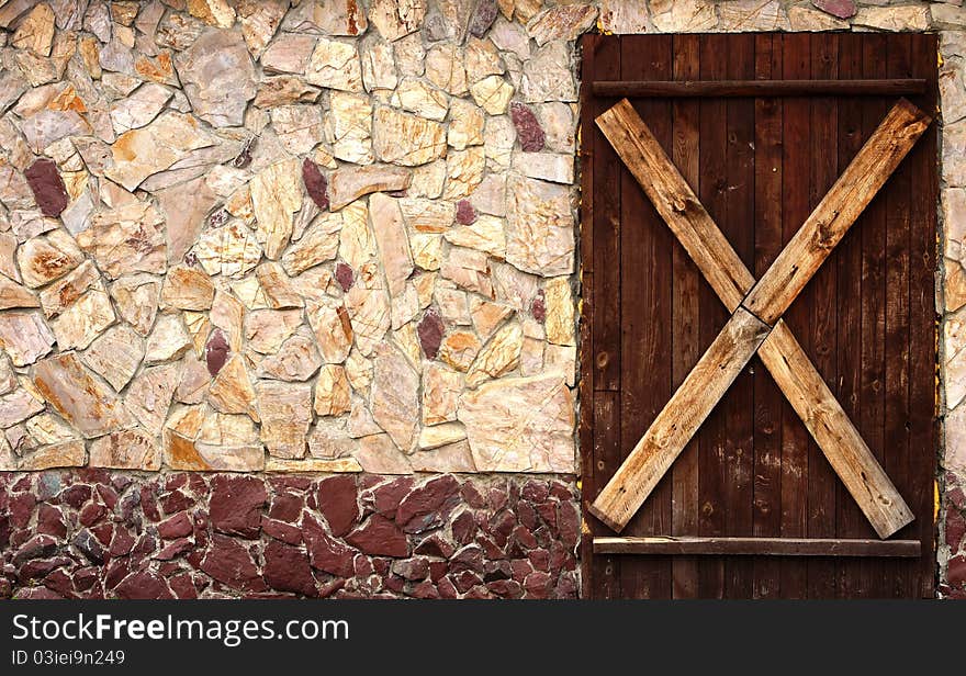 An old nailed-up door and a wall. An old nailed-up door and a wall