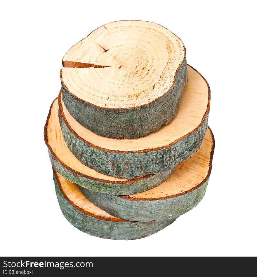 Stacked wooden cross sections on white background