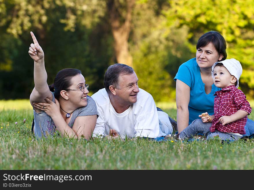 Grandpa, daughters and niece on grass