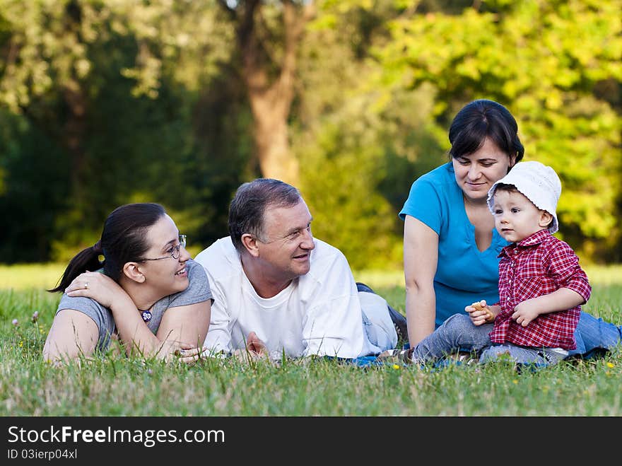 Grandpa, daughters and niece on grass