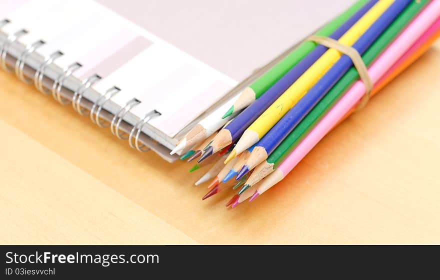 Colored Pencils with Art Book On Table