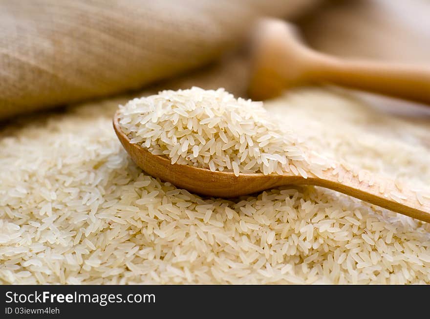 Raw rice and wooden spoon