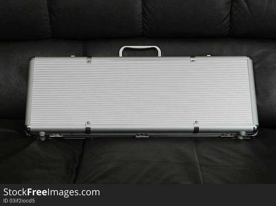 Metal poker suitcase on the black background. Metal poker suitcase on the black background