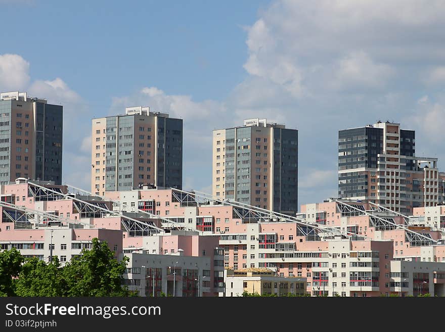 Modern multifamily housing on the blue sky