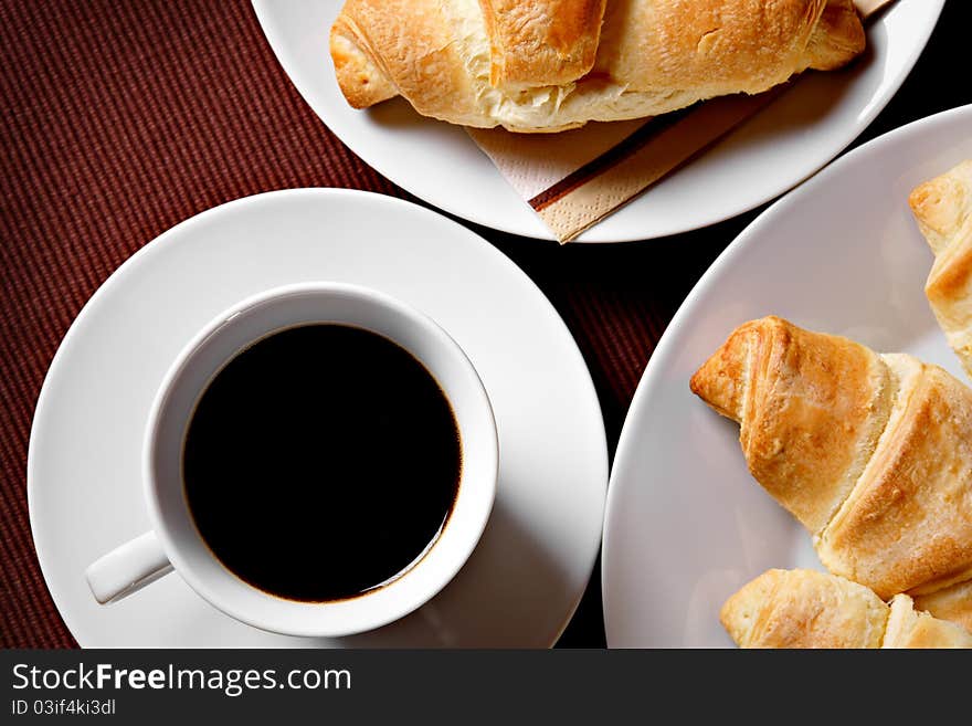 Cup of coffee with fresh warm croissants. Cup of coffee with fresh warm croissants