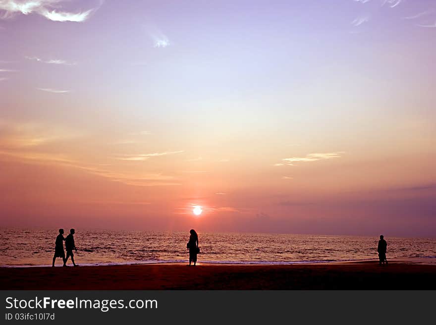 People on the ocean beach at sunset. Sri Lanka