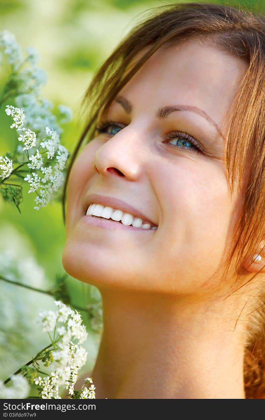 Happy young woman and wild flowers.