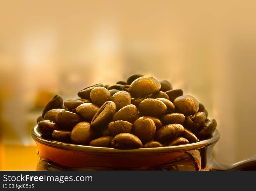 Closeup of coffee beans in a small pot with copyspace