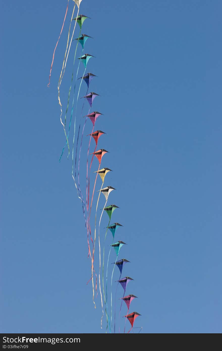 Kites against a vivid blue sky. Selective focus, shallow DOF