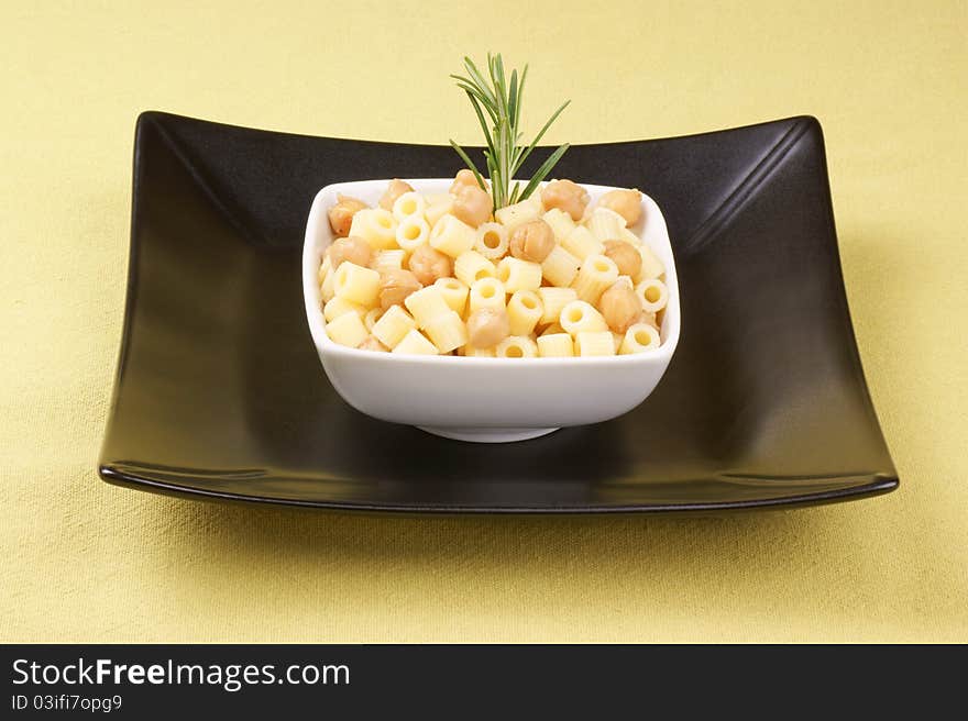 Ditalini with chickpea and rosemary served in a white plate