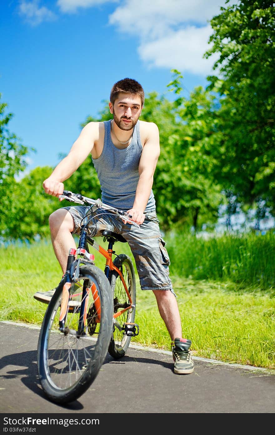 Young man cyclist sitting on bicycle