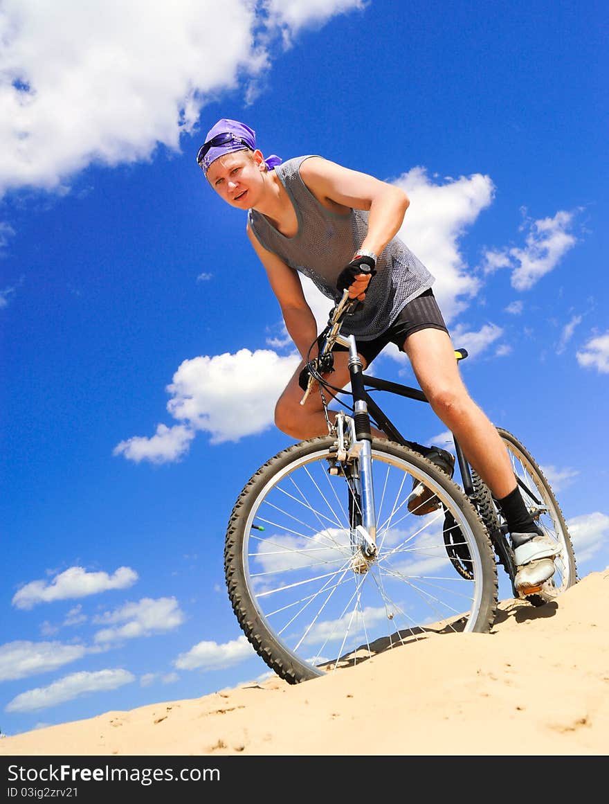 Young men riding a bike downhill style. Young men riding a bike downhill style