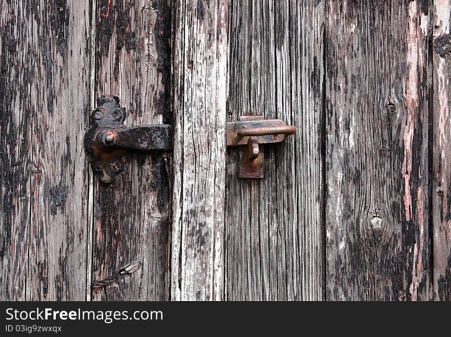 Old gray wood door with a lock