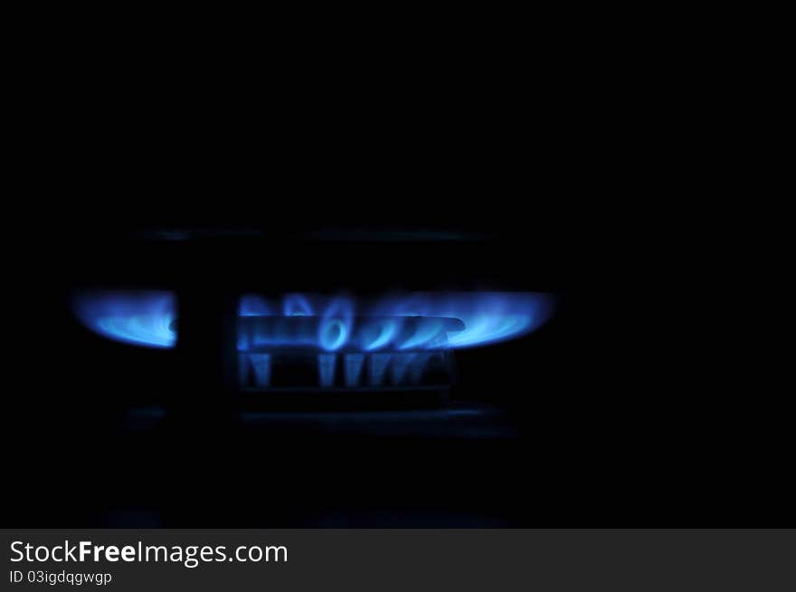 The gas burns with a blue flame on the oven.