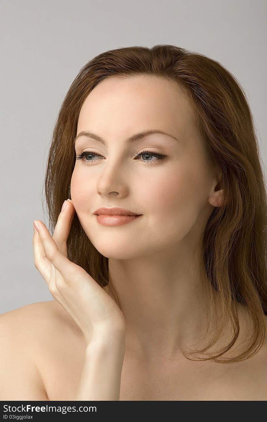 Portrait of young girl with hand at face. Portrait of young girl with hand at face