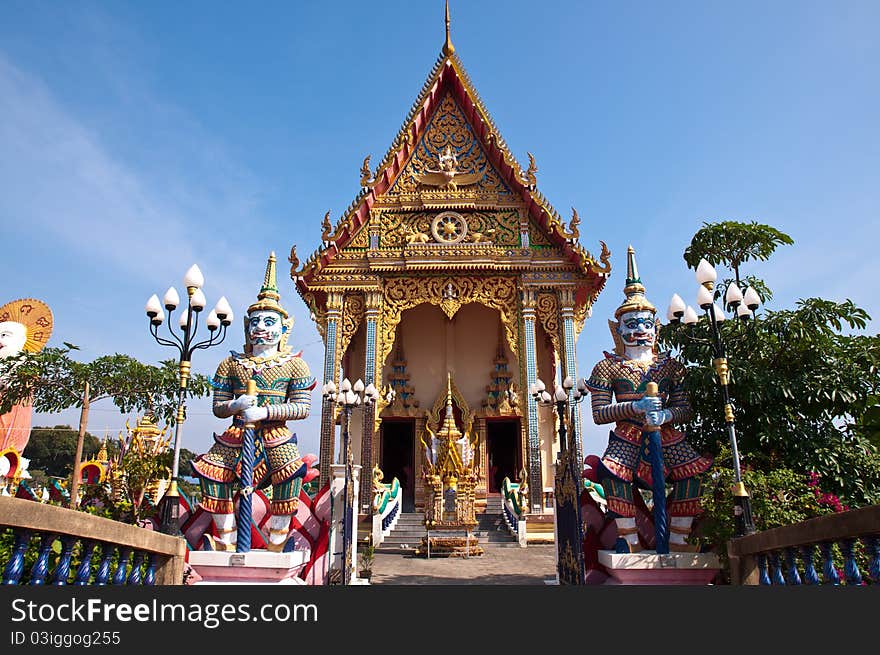 Thai temple with giant at the gate with clear sky background