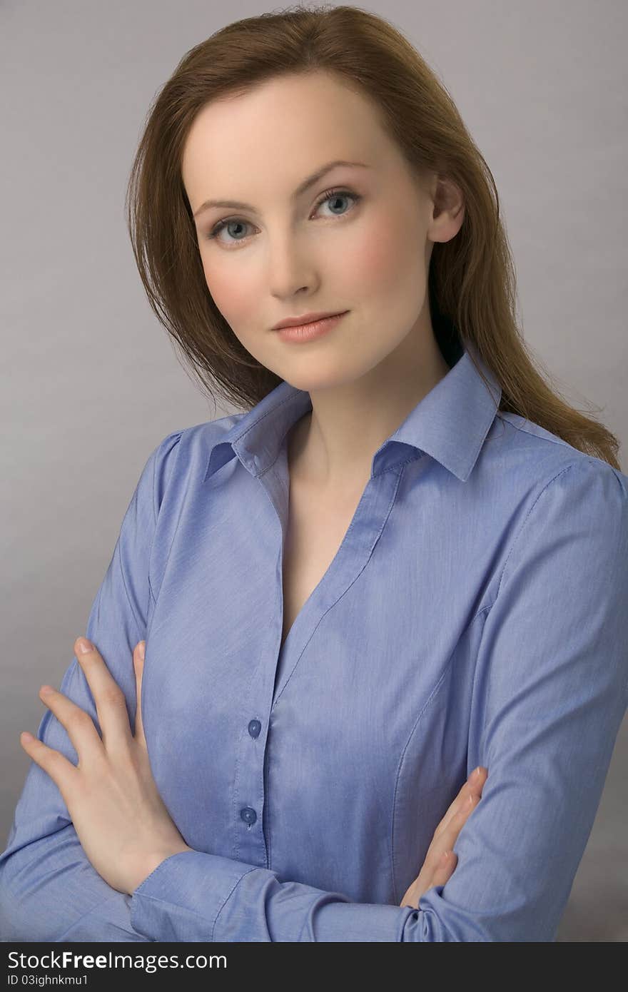 Portrait of young business woman with chestnut hair and in dark blue blouse. Portrait of young business woman with chestnut hair and in dark blue blouse