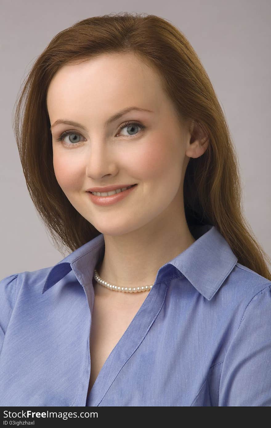 Portrait of young business woman with chestnut hair and in blue blouse. Portrait of young business woman with chestnut hair and in blue blouse