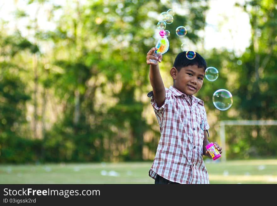 Asian Boy Playing Balloon Gun Toy