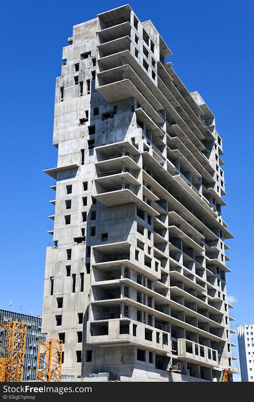 Construction of a monolithic high-rise buildings against the blue sky. Construction of a monolithic high-rise buildings against the blue sky.