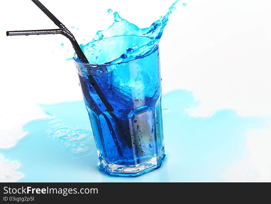 Blue cocktail with splashes isolated on white