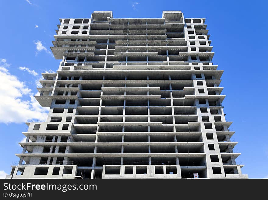 Construction of a monolithic high-rise buildings against the blue sky. Construction of a monolithic high-rise buildings against the blue sky.