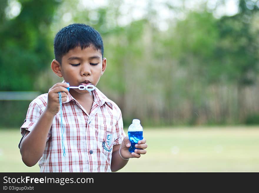 Young boy enjoy blowing bubbles. Young boy enjoy blowing bubbles