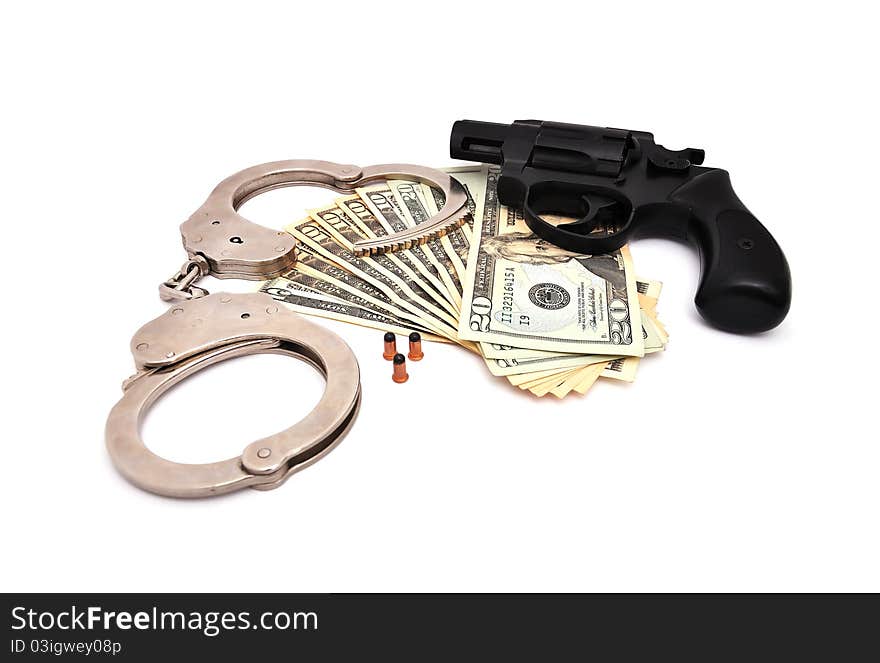 Revolver, dollars and the handcuffs on a white background. Revolver, dollars and the handcuffs on a white background