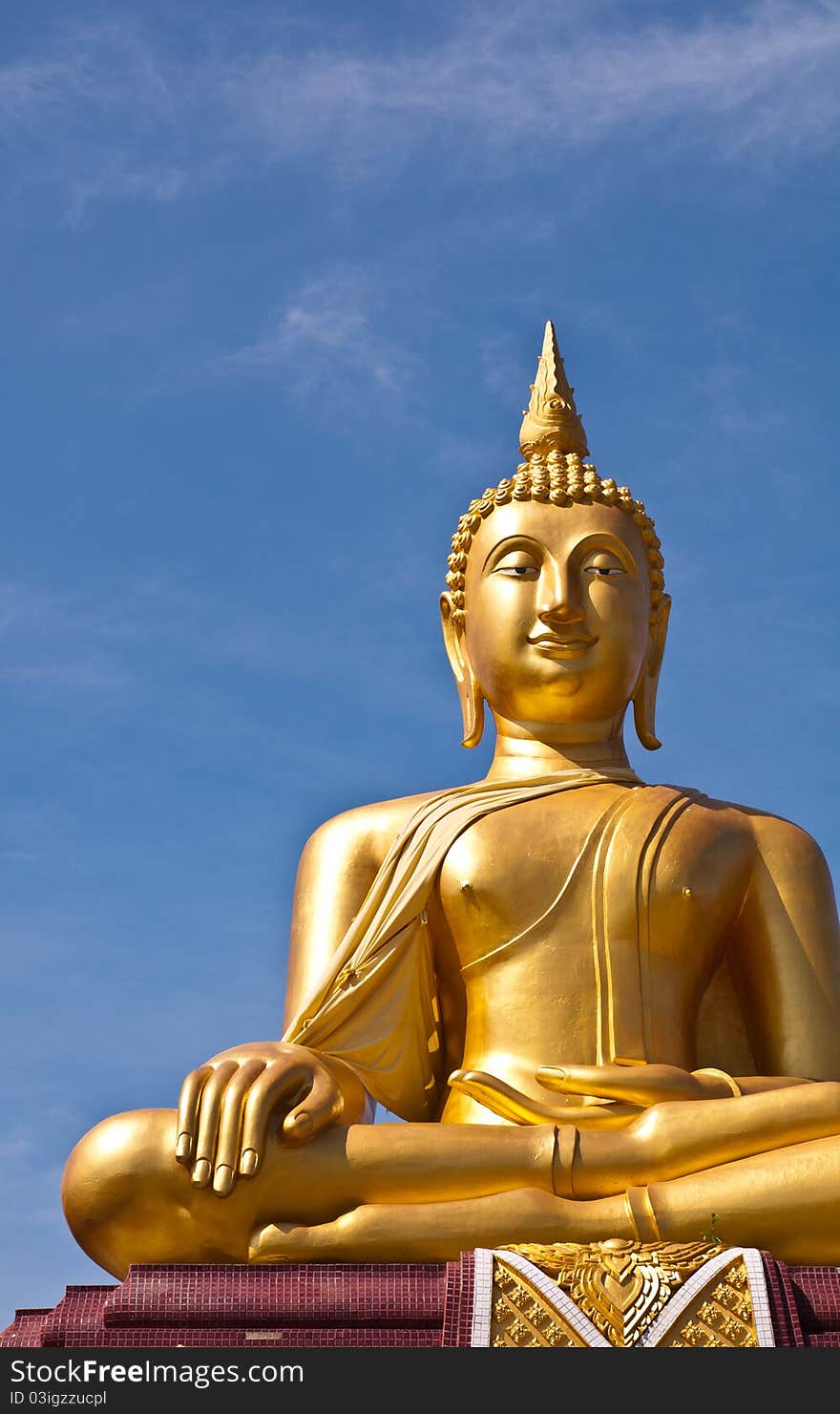 Golden buddha statue with blue sky background