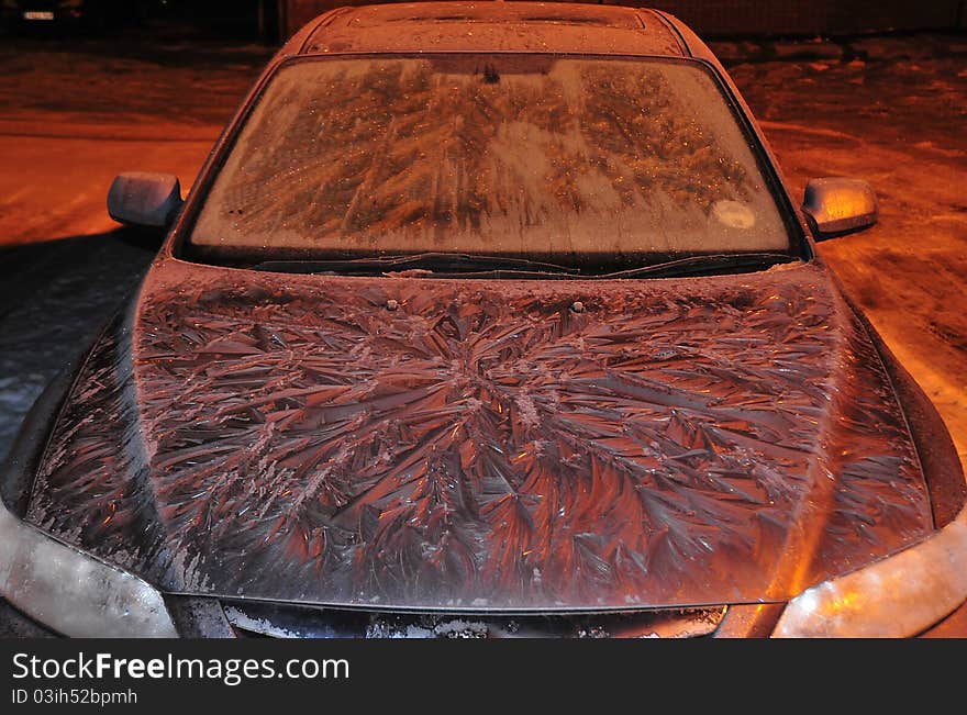 Shot of a car in extreme cold weather with interesting ice fronds formed on the bonnet shot under sodium lighting. Shot of a car in extreme cold weather with interesting ice fronds formed on the bonnet shot under sodium lighting