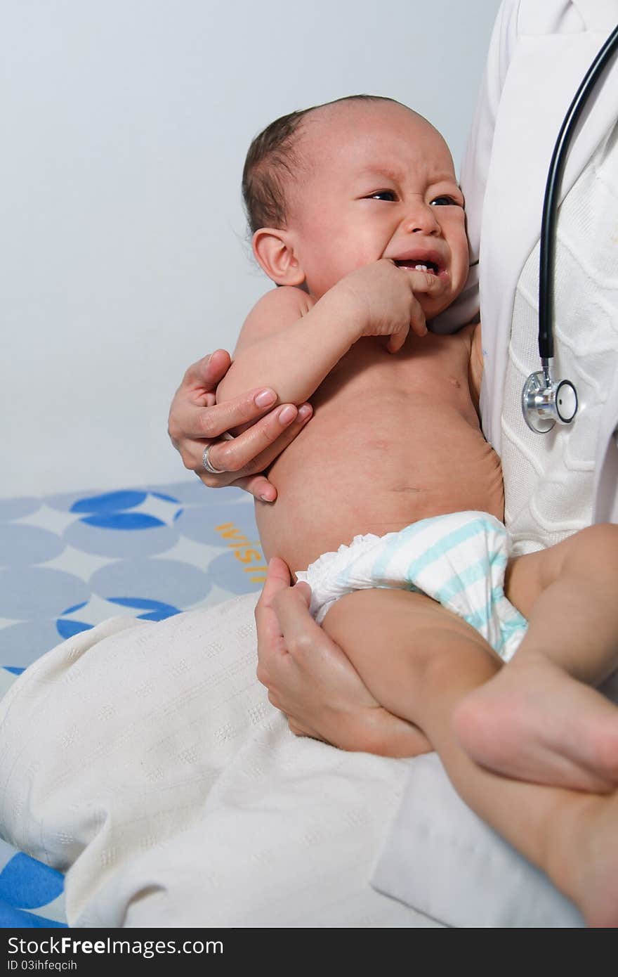 A baby boy got measles and being taken care of by a female doctor. A baby boy got measles and being taken care of by a female doctor