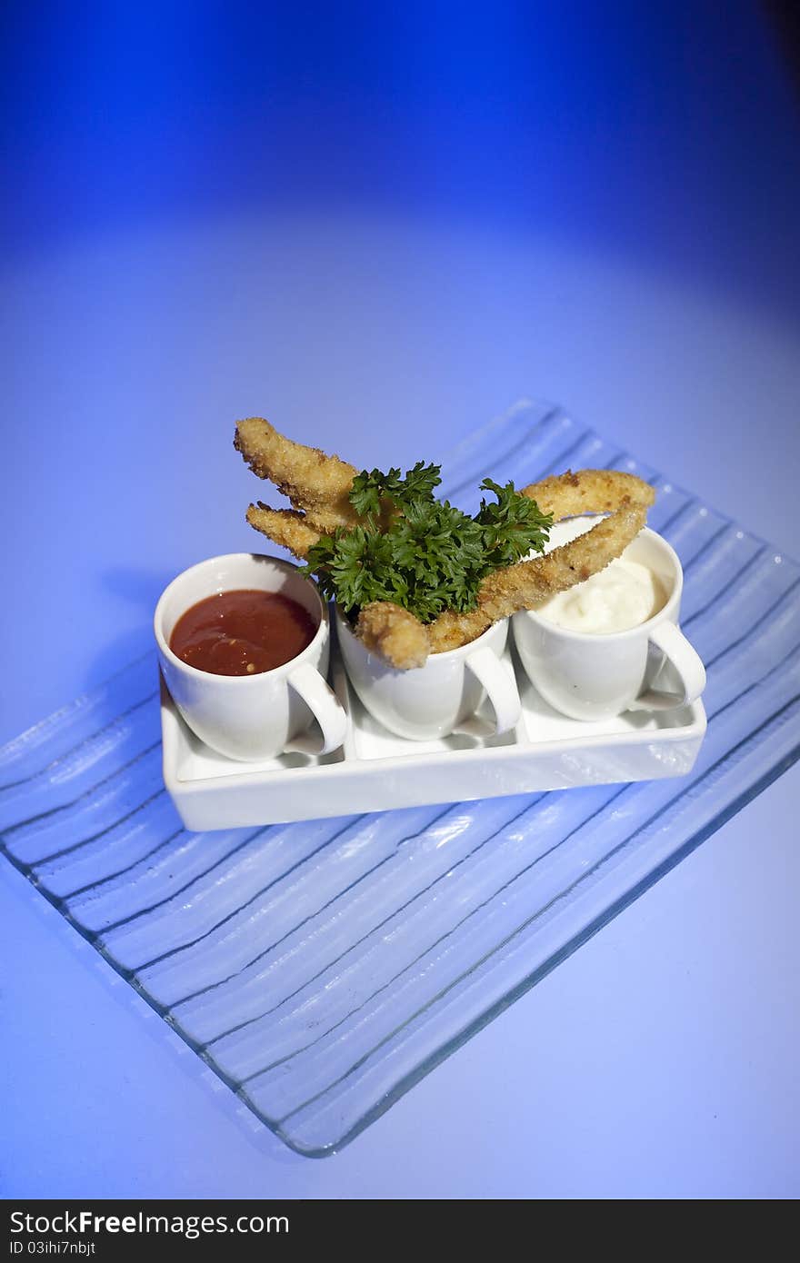 Chicken finger shot with tomato sauce and mayonnaise