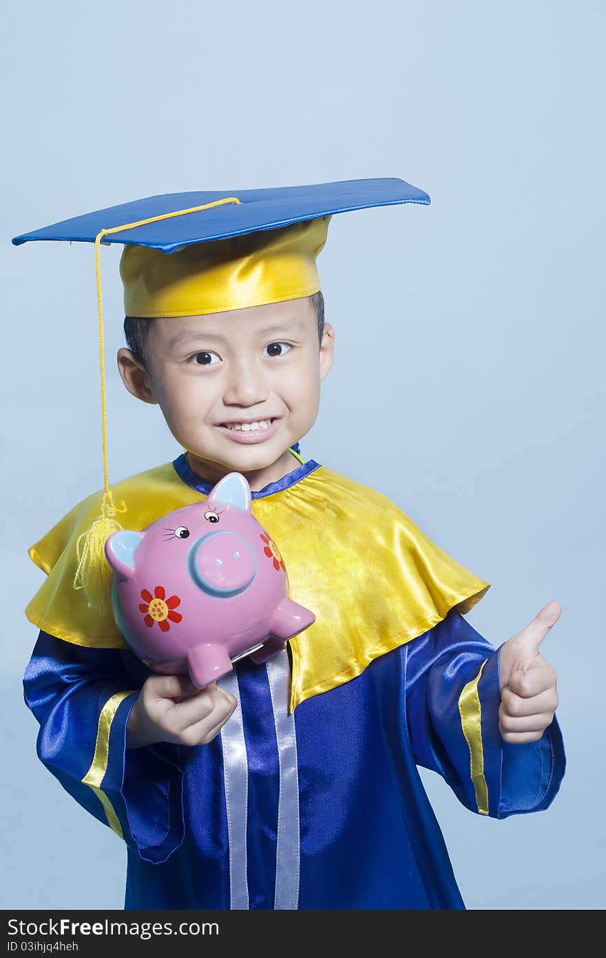 Scholar dressed toddler carrying piggy bank. Scholar dressed toddler carrying piggy bank