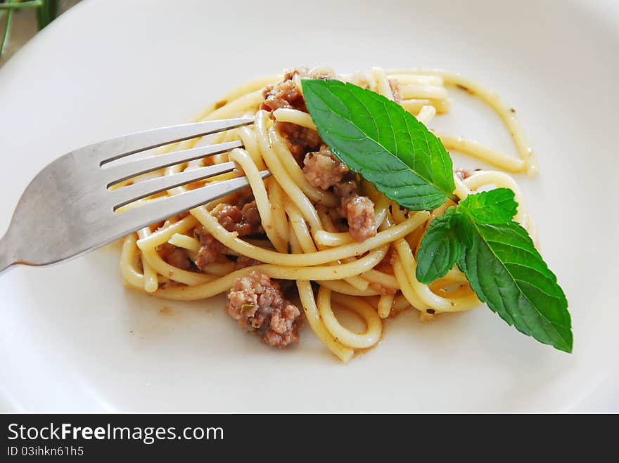 Small portion of spaghetti mixed with minced meat served on white plate. Small portion of spaghetti mixed with minced meat served on white plate