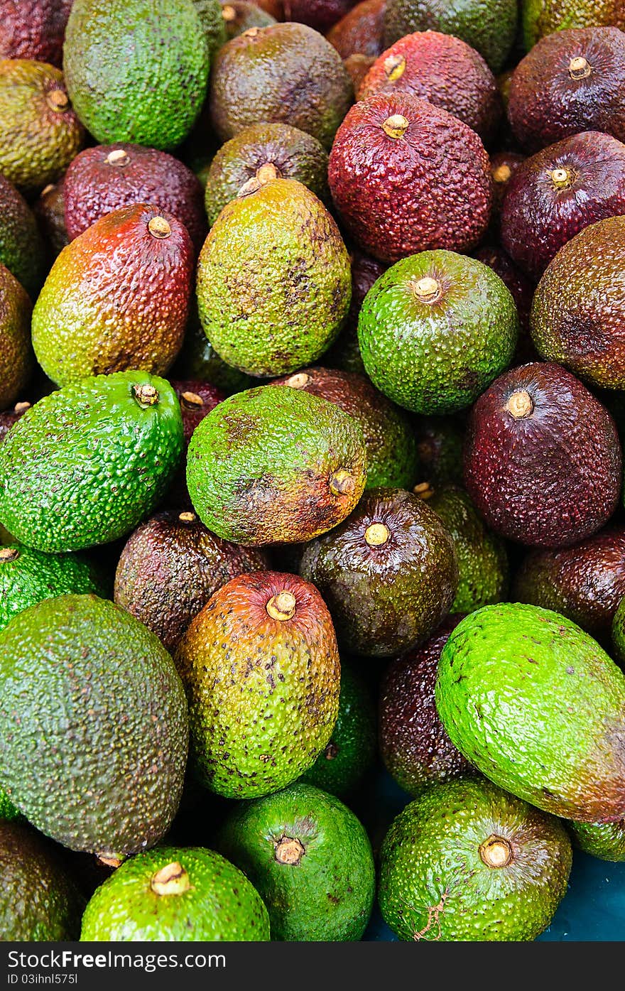 Pile of fresh Avocados in a market stand