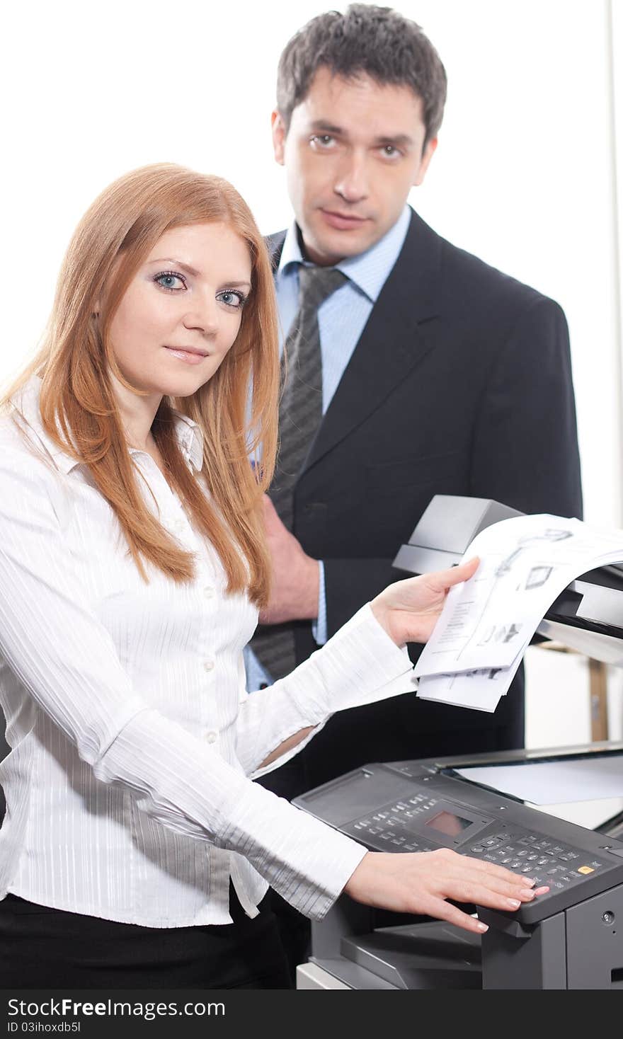 Positive girl with documents near copy machine