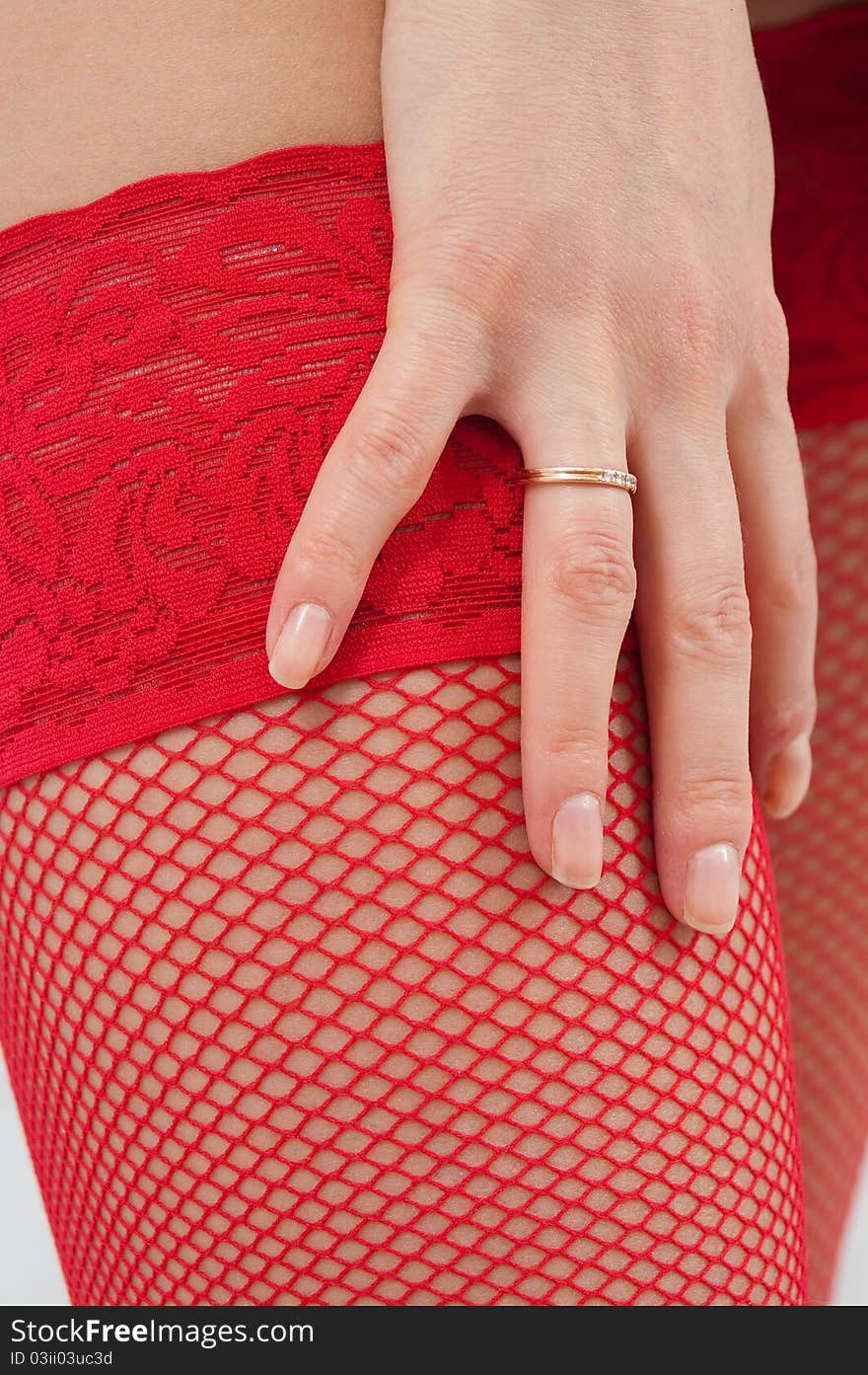 Woman s legs in red fishnets and high-heels