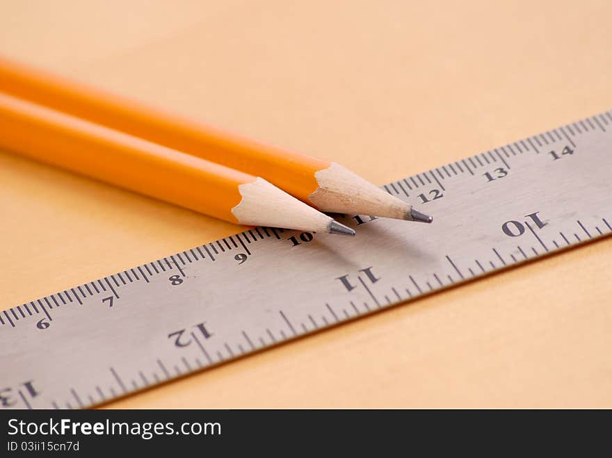 Two Sharpened Pencils On Metal Ruler. Two Sharpened Pencils On Metal Ruler