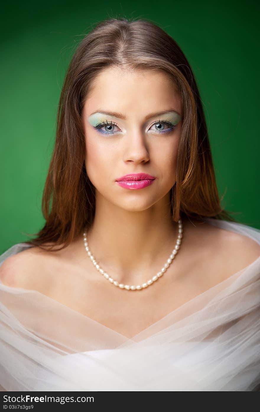 Portrait of a pretty girl on the green background