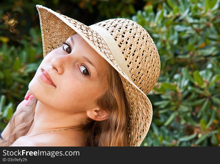 Portrait of teen girl in a straw hat. Portrait of teen girl in a straw hat.